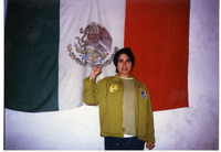 Michele Serros in front of a Mexican flag thumbnail