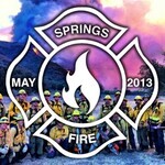Group of firefighters with smoke from the hillside behind thumbnail