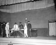 Players performing on stage. thumbnail