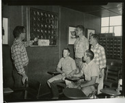 [Professor showing four students horseshoes in classroom] thumbnail