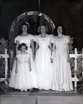 Teenage girls and a little girl dressed in long white formal dresses. thumbnail