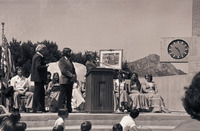[President Robert E. Kennedy holds up a framed photo of Cal Poly Rose Float] thumbnail