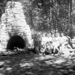 A group of young women posing by an outdoor stone hearth thumbnail