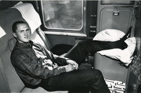 [Fred Brown with his feet up on a train] thumbnail
