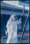 Melissa on swing with doll thumbnail