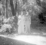 Women posing with a forest in the background thumbnail