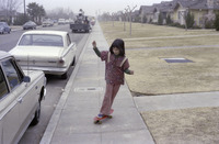 Diane Gomez skate boarding on sidewalk thumbnail