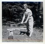 Teenage girl posing as if chopping a log with an axe thumbnail