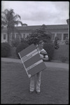 ASI President holding giant book titled 'Look, Governor' at Dexter thumbnail