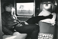[Fred Brown with his feet up on a train] thumbnail