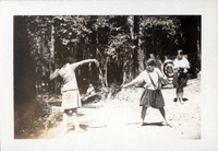 Two girls sword fighting in a forest thumbnail