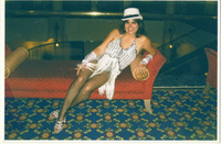Michele Serros posing on a couch thumbnail