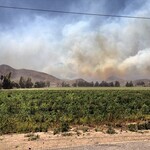 Smoke from the hillside seen from afar thumbnail