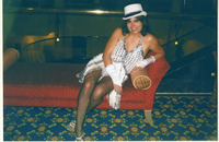 Michele Serros posing on a couch thumbnail