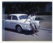 Michele Serros standing next to a car thumbnail