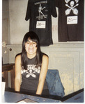 Michele sitting at The Fuzztones Merchandise Booth thumbnail