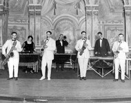 Musicians performing on stage. thumbnail