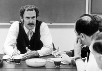 Four faculty members in a classroom. thumbnail