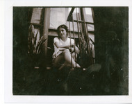 Michele Serros sitting on a window ledge thumbnail