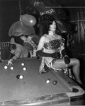 Female impersonator sitting on pool table thumbnail