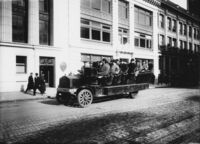 Group of congressmen in open air touring bus Pacific No. 9 on street thumbnail