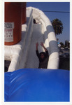 Michele Serros sliding down in a bounce house thumbnail