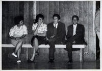 Teenage girls and boys sitting on a bench thumbnail