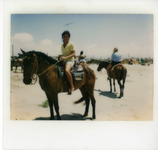 Michele Serros riding a horse thumbnail