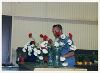 [Man examining flowers] thumbnail