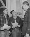 [Captain William S. Fairchild discussing the army with two young Nisei volunteers] thumbnail