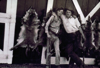Ray Ayres and Lawrence Outland with Coyote Hides on Barn thumbnail