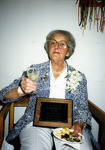 Mae Dailey posing with her plaque thumbnail