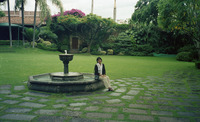 Michele Serros sitting on a fountain in Puebla, Mexico thumbnail