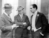 Three men conversing. thumbnail