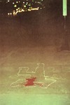 White outlines of fallen bodies, with a few splashes of blood red paint thumbnail