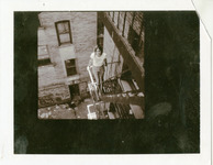 Michele Serros on a fire escape thumbnail