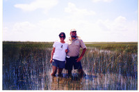 Michele Serros and a park ranger standing in a marsh thumbnail