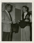 [Dick Anderson and student holding swimming trunks] thumbnail