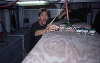 Tom checking IGR (individual growth rate) experiment in aquarium room on Duke thumbnail