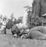Male student sleeping on the lawn thumbnail