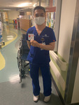 Photograph of Nurse Cuong Phu Pham Holding a Small Sign in Support of Nurses thumbnail