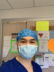 Photograph of Nurse Cuong Phu Pham in Front of Cork Board thumbnail