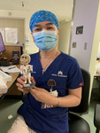 Photograph of Nurse Cuong Phu Pham Holding a Figurine thumbnail