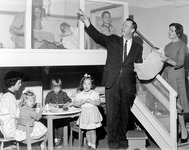 Joyce Bolton with an unidentified man, children and students. thumbnail