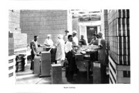 Cannery workers hand labeling cans. thumbnail