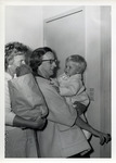 Mrs. Martin Rowe and Mrs. Fred May holding a toddler thumbnail