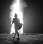 Student walking in front of bonfire thumbnail
