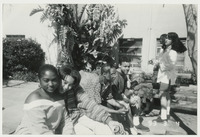 [Students of color seated near Dexter building] thumbnail