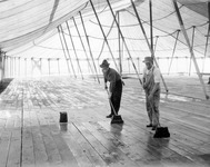 Two men oiling the floor thumbnail