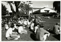 Students sitting on lawn outside Architecture building and Education building thumbnail